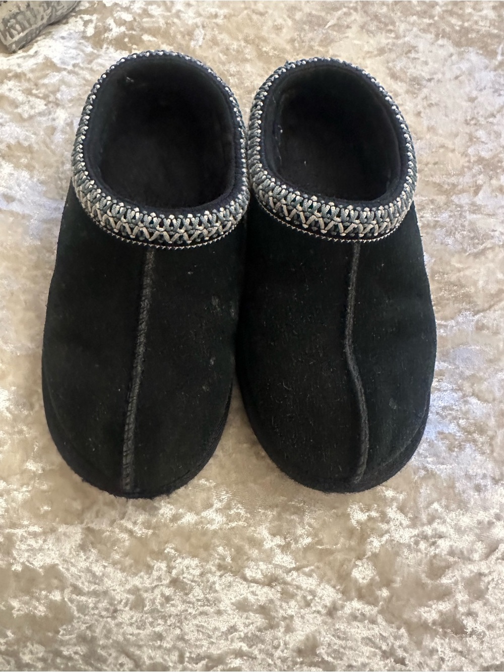 Cozy Black UGG Suede Slip-On Slippers with Decorative Trim